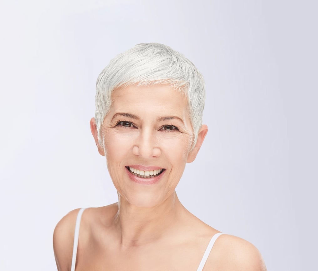 Smiling woman with short white hair